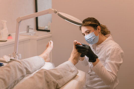 Chiropodist examining the female feet. Healthcare. Woman body care. Spa treatment.