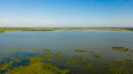 Tropical landscape: Lake and mountains in the distance on Sri Lanka. Arugam Lagoon.