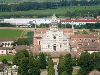 Naklejka premium Aerial view of the Certosa di Pavia at sunny day, built in the late fourteenth century, courts and the cloister of the monastery and shrine in the province of Pavia, Lombardia, Italy
