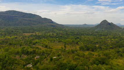 Top view of Rustic landscape with agricultural lands and farms among mountains and forests. Sri Lanka.