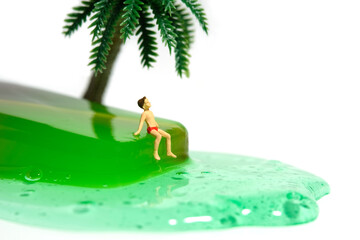 Miniature people toy figure photography. Creative summer vacation concept. A kid sitting and relaxing above green watermelon melting ice cream. Isolated on white background