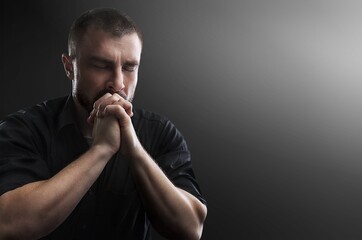 The boy folding his hands in prayer to god. prayer to God for happiness and a better life. Repent...