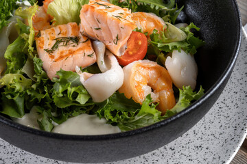 Salmon steak, squid, shrimp with salad to the New Year's table.