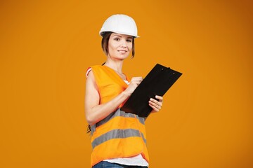 Smiling young woman in hardhat posing