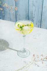 Gin cocktail with lemon and thyme.