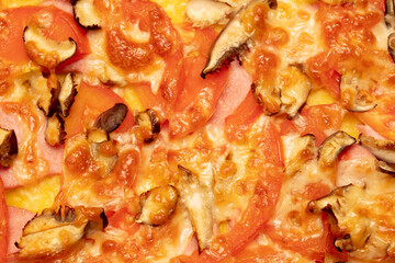 Pizza with tomatoes and sausage as a background.