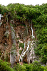 Fototapeta na wymiar Beautiful splashes of water on waterfalls in Croatia national park Plitvice lakes