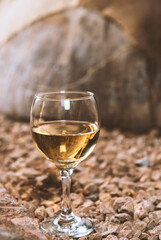 a glass of white wine in a wine cellar
