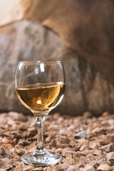 a glass of white wine in a wine cellar
