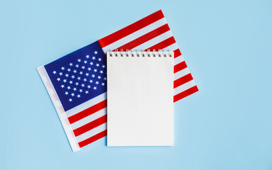 American flag with open notebook or list on blue background. United states, USA flag. Happy Independence day, memorial day, fourth 4th of july concept. Flat lay, top view, place for text