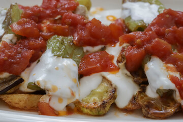 Traditional delicious Turkish food, yoghurt with garlic, fried mixed vegetables (potato, eggplant, roasted pepper), Turkish name; mixed stir-fry vegetables