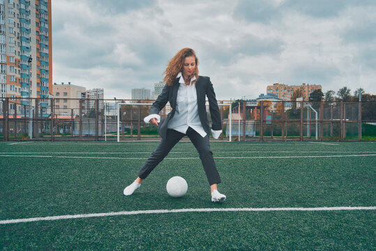 woman soccer player with ball on the field. ball dribbling, feint.