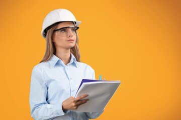 Smiling young woman in hardhat posing