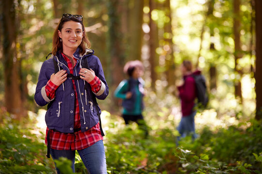 Portrait Of Woman With Group Of Female Friends On Camping Holiday Hiking In Woods Together