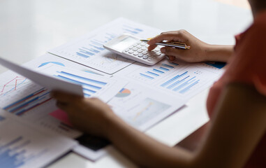 Accountant working on desk office with using a calculator to calculate the numbers and audit. Finance accounting concept.