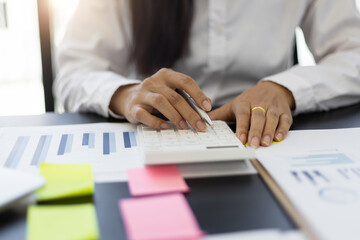 Obraz na płótnie Canvas Close up woman accountant work on financial documents and use budget analysis calculators.