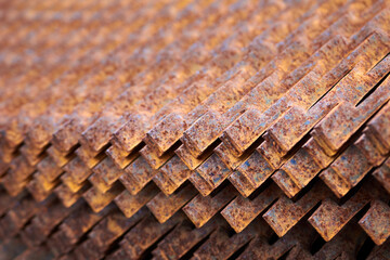Perforated rusty metal sheets stamping plates texture closeup side view. Made through metal stamping sheet metal manufacturing lightweight bearing elements structural combine strength functionality