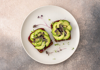 Sandwiches with boiled beetroot and avocado with microgreens, delicious healthy breakfast