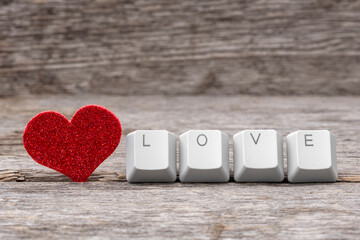 Red heart and word LOVE written on keyboard keys