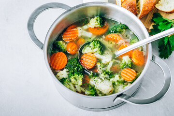 Vegetable soup. Spring broccoli, cauliflower, carrots soup in pot.