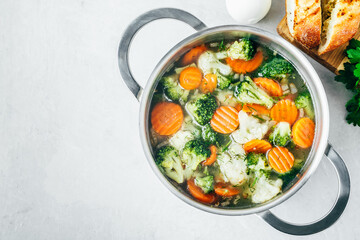 Vegetable soup. Spring broccoli, cauliflower, carrots soup in pot.