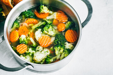 Vegetable soup. Spring broccoli, cauliflower, carrots soup in pot.
