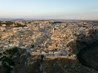 Fototapeta na wymiar View from above, stunning aerial view of the Matera’s skyline during a beautiful sunrise. Matera is a city on a rocky outcrop in the region of Basilicata, in southern Italy.