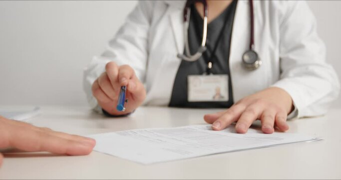 Doctor explaining examination results to patient, close-up.