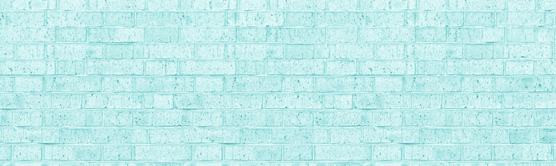 Light turquoise shabby color old rough brick wall wide texture. Old bright teal masonry widescreen...