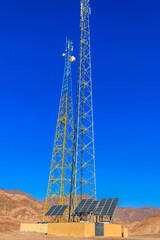 Communication towers and solar panels in a bedouin village in Sinai desert, Egypt
