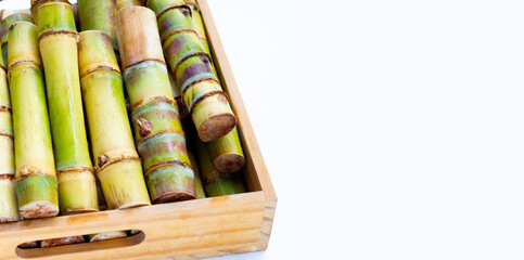 Sugar cane in wooden box on white background.