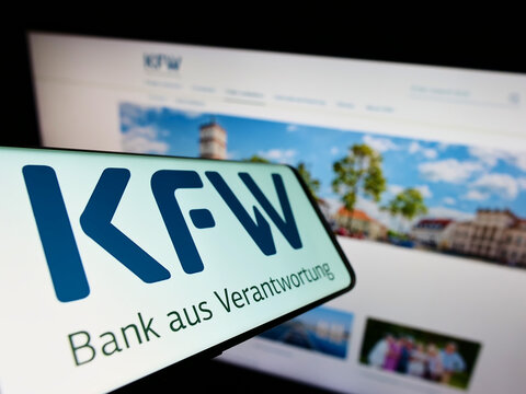 Stuttgart, Germany - 06-10-2022: Smartphone with logo of German bank Kreditanstalt f&uuml;r Wiederaufbau (KfW) on screen in front of website. Focus on center-left of phone display.