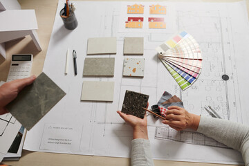 Architect and interior designer discussing floor tile and walls color for project