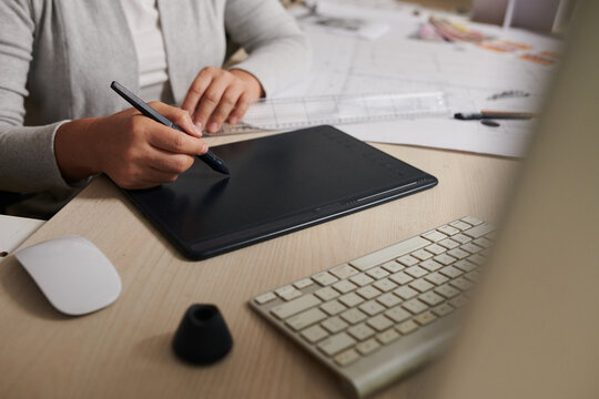 Closeup image of architect working on graphic tablet when working on apartment plan