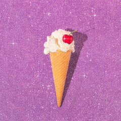 Summer creative layout with ice cream cone and cherry on purple sparkle background.  70s, 80s or...