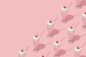 Retro romantic creative pattern with strawberry milkshake with cherry on top on pastel pink background. 70s, 80s or 90s retro fashion aesthetic idea. Valentines day romantic idea.