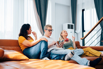 Obraz premium Happy family mother father and daughter at home on couch, Time Together. 