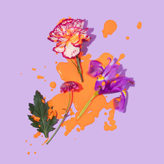 Spring or summer modern layout with three flower heads and orange paint spill on it on pastel...