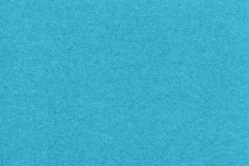Texture of light blue and turquoise colors paper background, macro. Structure of dense cerulean craft cardboard.