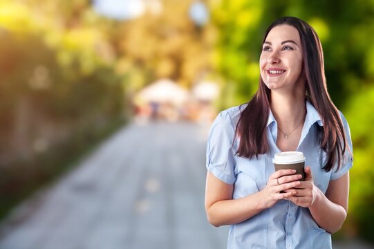 Portrait image of a beautiful young woman drinking coffee and relaxing with nature views