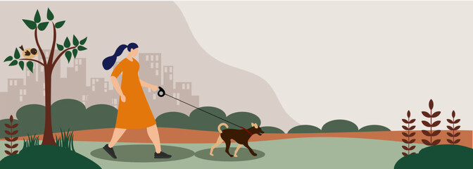 Young woman walking dog in park 