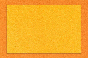 Fototapeta premium Texture of craft yellow paper background with orange border, macro. Structure of vintage dense kraft cardboard