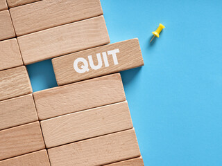 The word quit written on wooden blocks. To quit job or resignation - obrazy, fototapety, plakaty