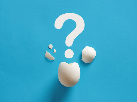 Cracked White Chicken Egg Shell With Question Mark Symbol. Surprise, Mystery, Uncertainty Or Baby Gender Prediction