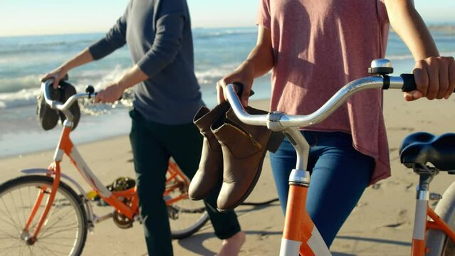 Animation of do it for them over midsection of caucasian couple with bikes on beach