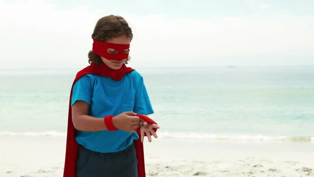 Animation of do it for them over happy caucasian boy in superhero mask on beach