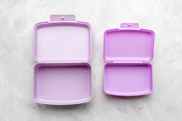 Empty purple lunch boxes, top view. Plastic container for food