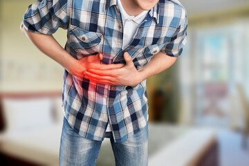 Man with stomach pain causes of abdominal pain include inflammatory bowel disease. stomach ulcer irritable bowel syndrome, ulcerative colitis and microvilli. - obrazy, fototapety, plakaty