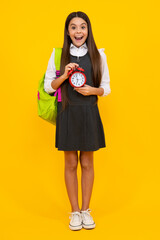 School and education concept. Back to school. Schoolchild, teenage student girl with clock alarm, time to study. Excited face, cheerful emotions of teenager girl.