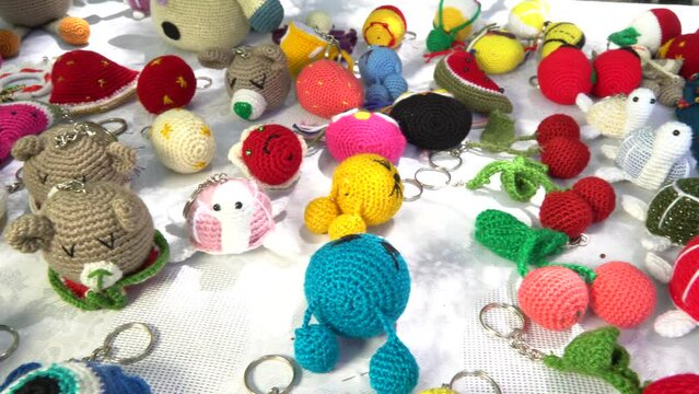 detail images from a market of hand-knitted key chains and bath fibers.